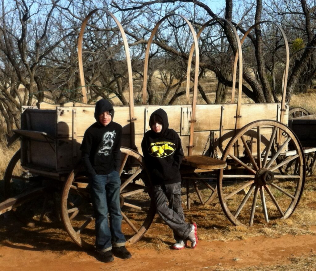 Boys by an old wagon